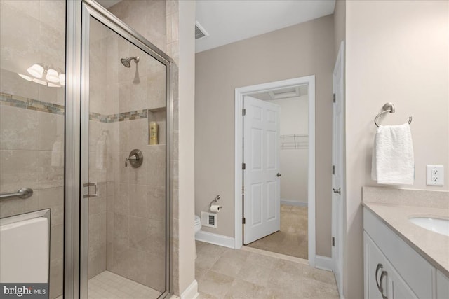 bathroom with vanity, tile patterned floors, and a shower with shower door