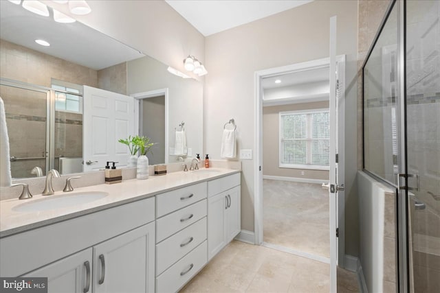 bathroom featuring tile patterned flooring, vanity, and walk in shower