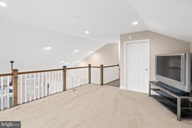 bonus room with light carpet and lofted ceiling