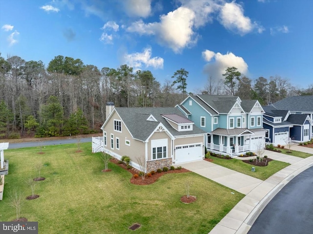 view of front of house featuring a garage, covered porch, and a front lawn