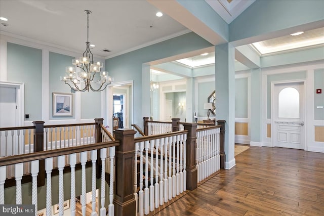 hall with crown molding, a chandelier, and dark hardwood / wood-style floors