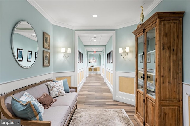 hallway featuring crown molding and light wood-type flooring