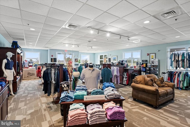 misc room featuring light colored carpet and a drop ceiling