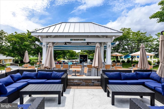 view of patio / terrace with a gazebo, ceiling fan, and outdoor lounge area