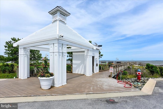 exterior space featuring a gazebo and a water view