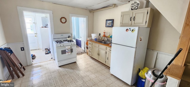 kitchen featuring white appliances and sink