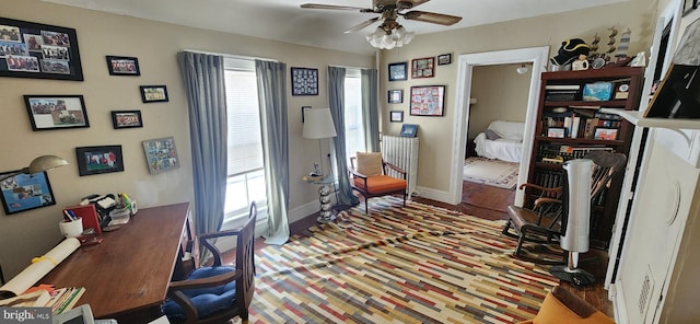 home office with wood-type flooring and ceiling fan