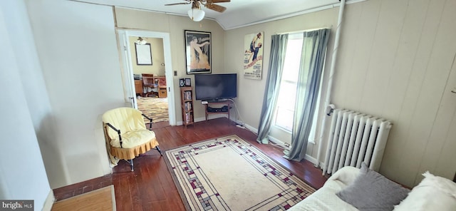 interior space with radiator, ceiling fan, and dark wood-type flooring