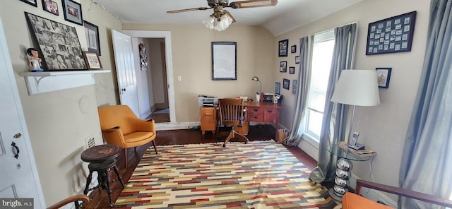 living area with hardwood / wood-style floors, ceiling fan, and vaulted ceiling