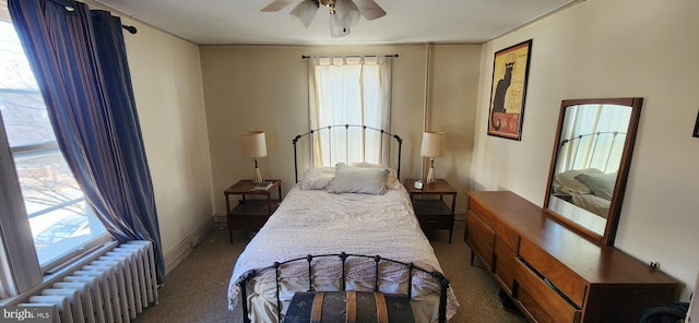 bedroom with carpet, ceiling fan, and radiator