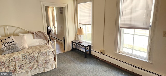 bedroom with carpet and a baseboard heating unit