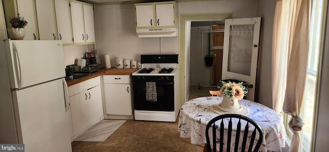 kitchen with white appliances and white cabinetry