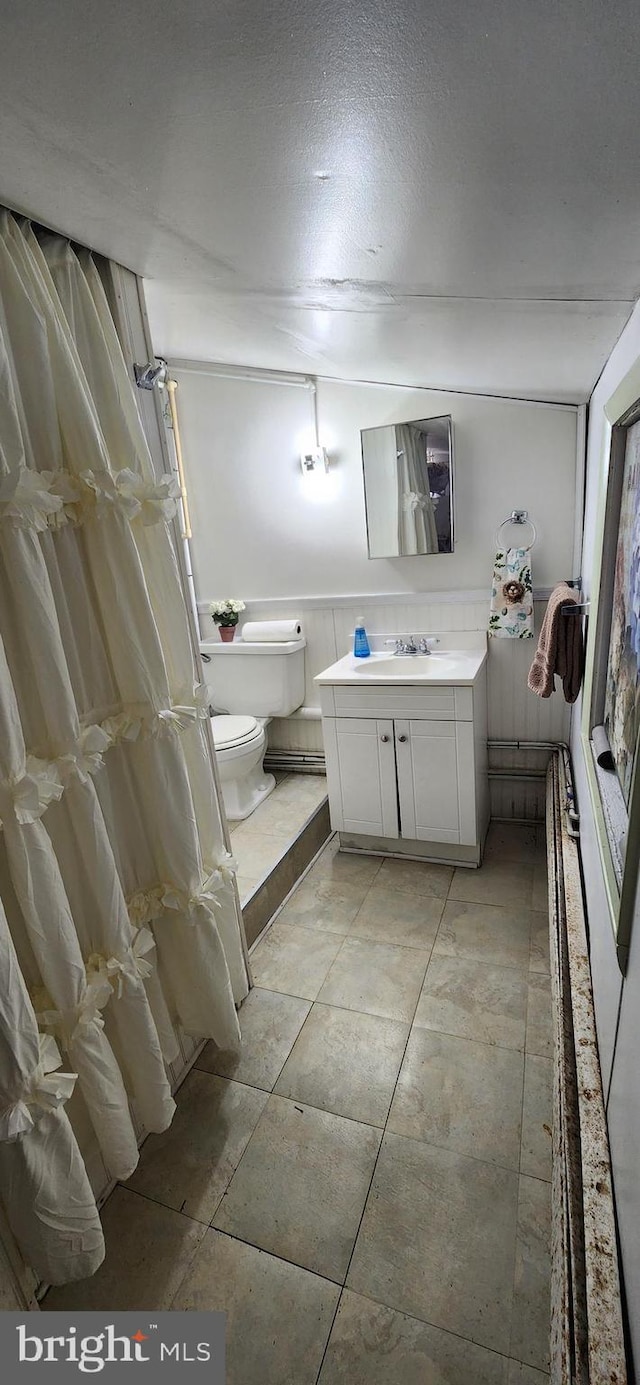 bathroom with vanity, a textured ceiling, and toilet