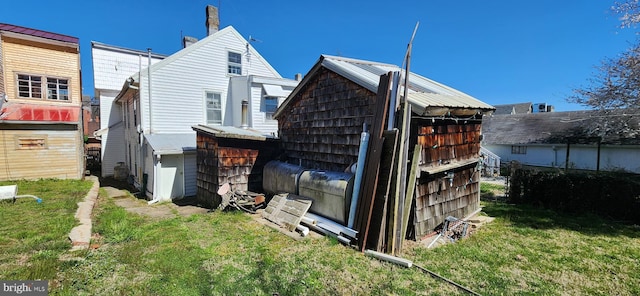 rear view of house featuring a yard