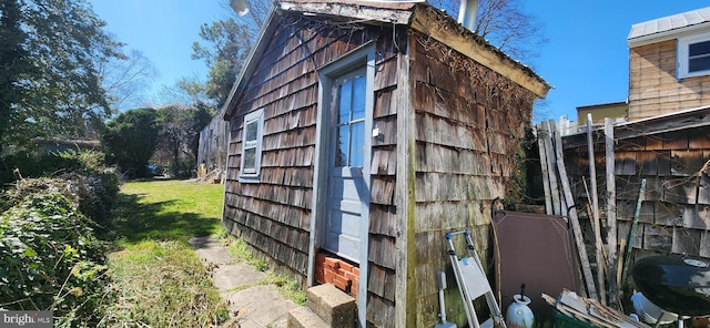 view of side of home with a lawn