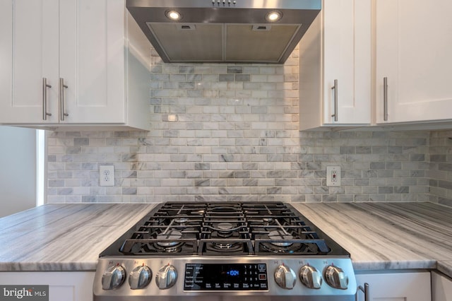 kitchen with white cabinets, tasteful backsplash, stainless steel range, and wall chimney exhaust hood