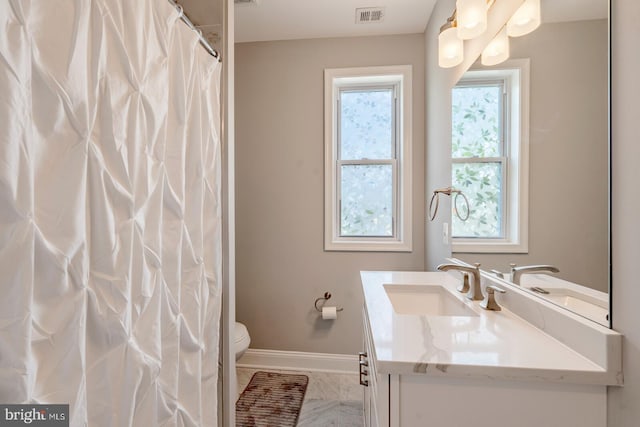 bathroom with vanity and toilet