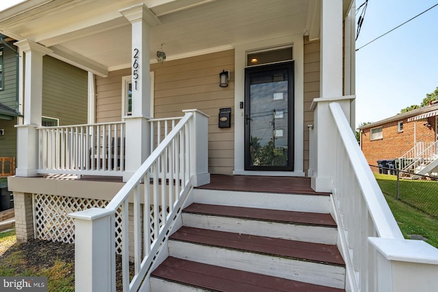 entrance to property featuring covered porch