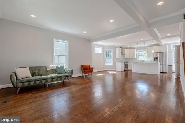 living room with ornamental molding, coffered ceiling, dark wood-type flooring, sink, and beam ceiling