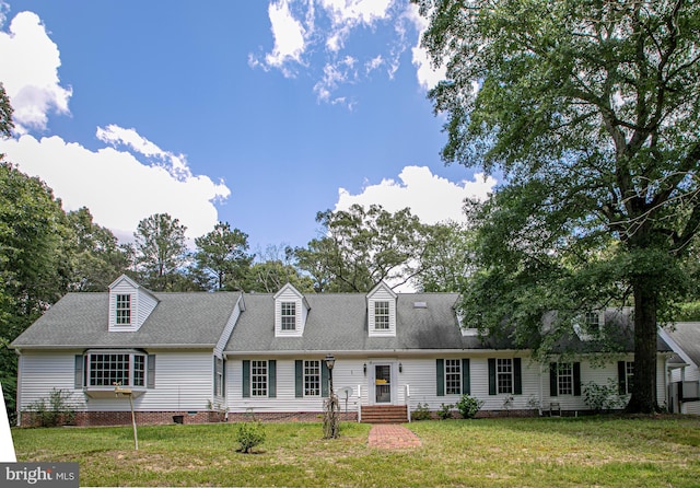 cape cod home with a front lawn