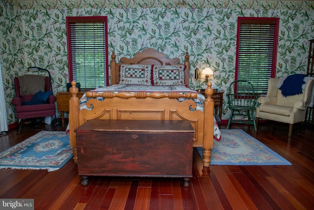 bedroom with dark hardwood / wood-style floors