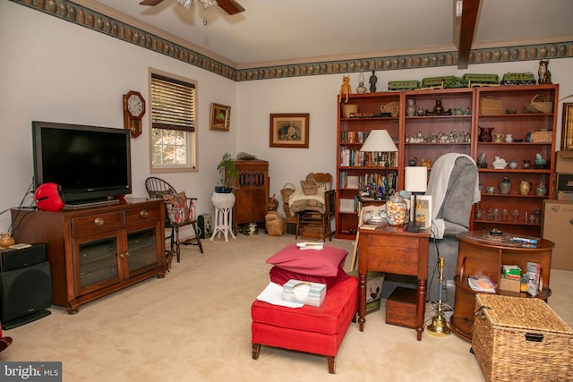 interior space with beam ceiling, light carpet, and ceiling fan