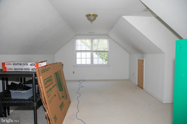 additional living space featuring light carpet and lofted ceiling