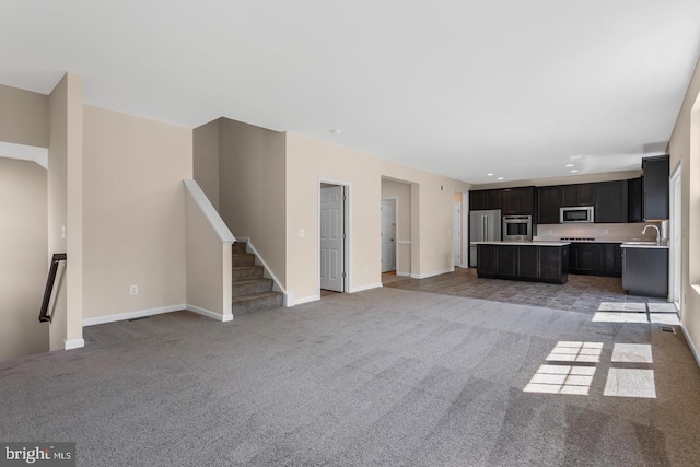 unfurnished living room featuring light carpet