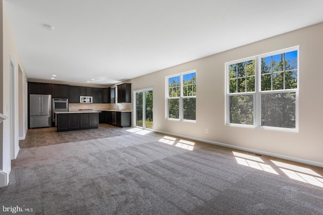 unfurnished living room with light carpet