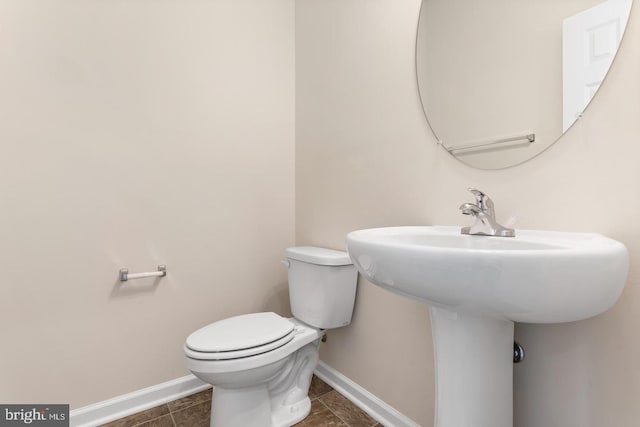 bathroom featuring tile patterned floors, toilet, and sink