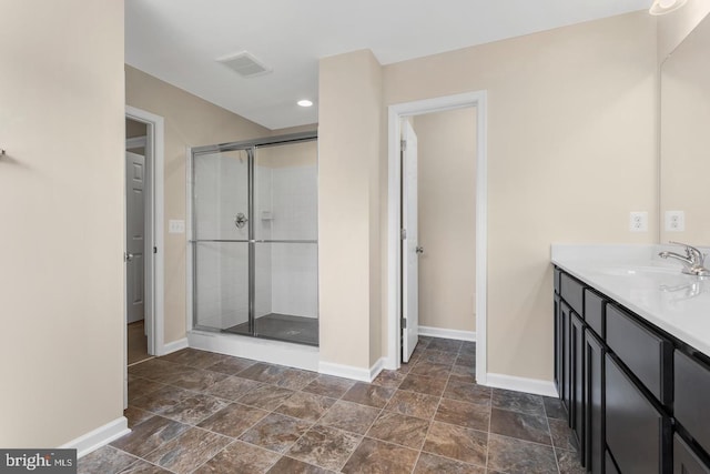 bathroom featuring vanity and an enclosed shower