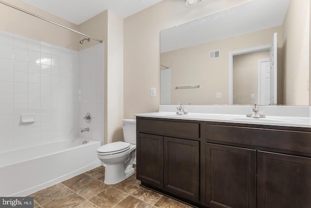 full bathroom featuring toilet, vanity, and tiled shower / bath