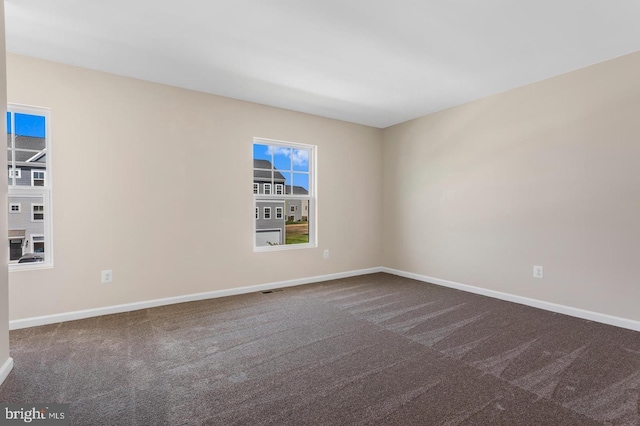 carpeted empty room with plenty of natural light