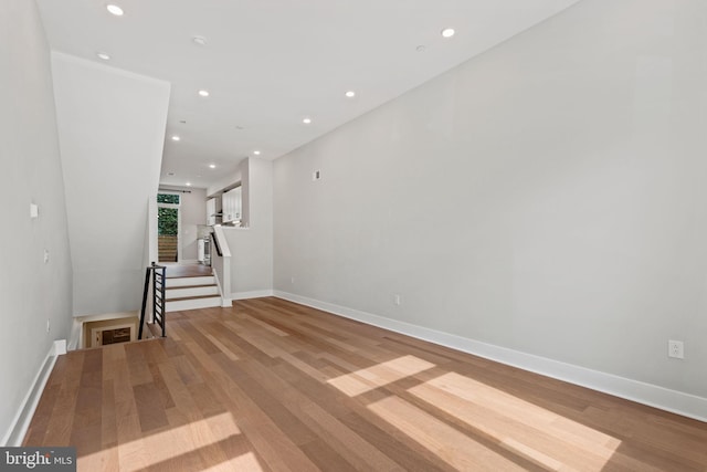 unfurnished room with light wood-style floors, baseboards, and recessed lighting