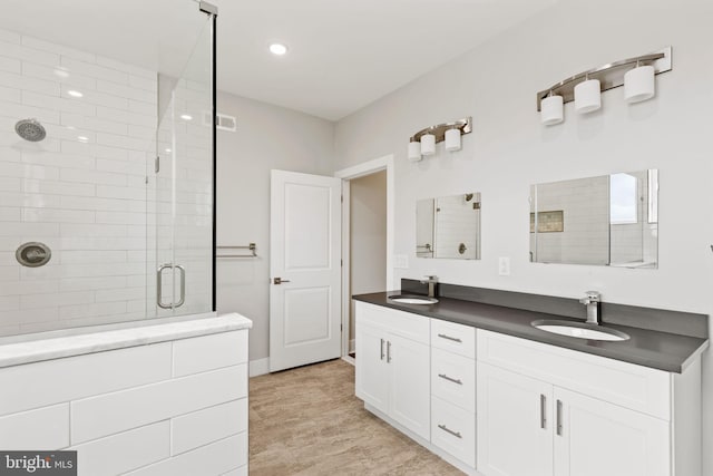 bathroom featuring vanity and an enclosed shower