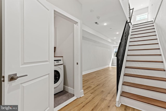 laundry room featuring light hardwood / wood-style flooring and washer / clothes dryer