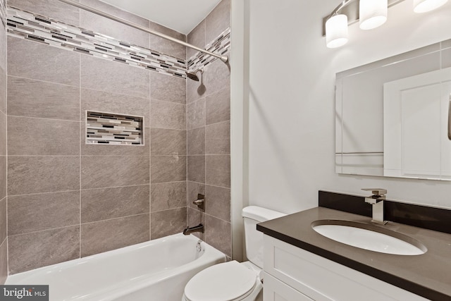 full bathroom with tiled shower / bath combo, vanity, and toilet