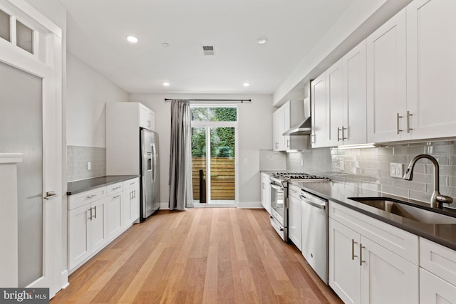 kitchen with light hardwood / wood-style floors, sink, white cabinetry, and appliances with stainless steel finishes