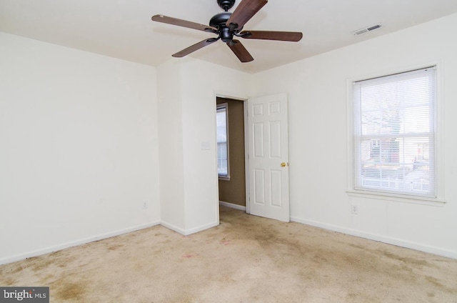 unfurnished room with light carpet and ceiling fan