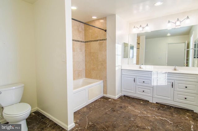 full bathroom with vanity, toilet, and tiled shower / bath