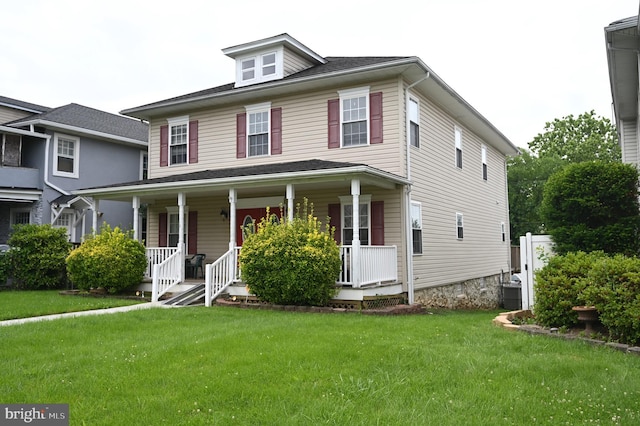 view of front facade with a front lawn and central AC