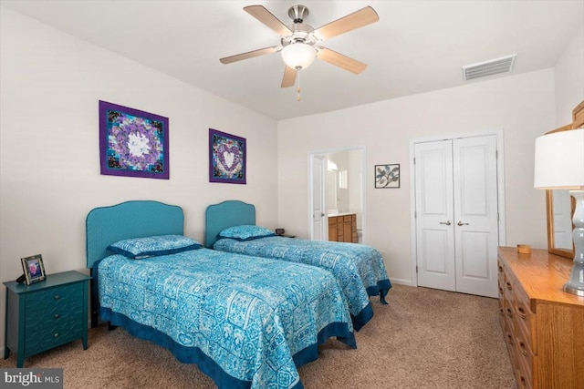 carpeted bedroom with ceiling fan, ensuite bathroom, and a closet