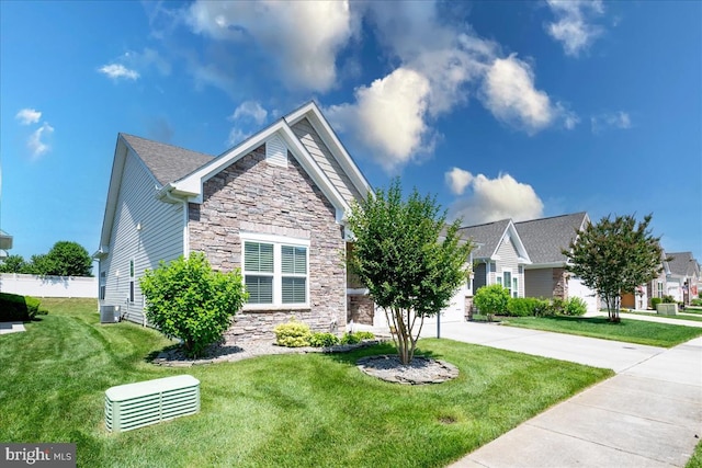 view of front of home featuring cooling unit and a front lawn