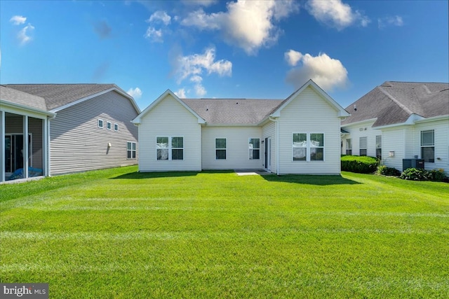 rear view of house with a yard