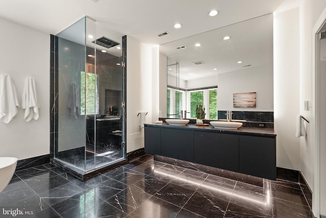 bathroom with marble finish floor, a stall shower, a sink, and recessed lighting