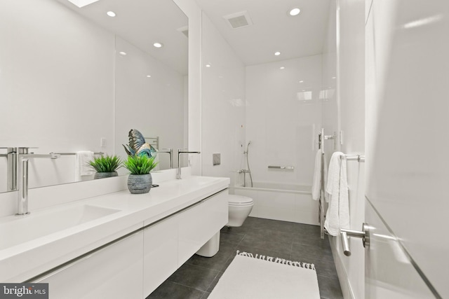 bathroom featuring shower / washtub combination, tile patterned flooring, a sink, and double vanity