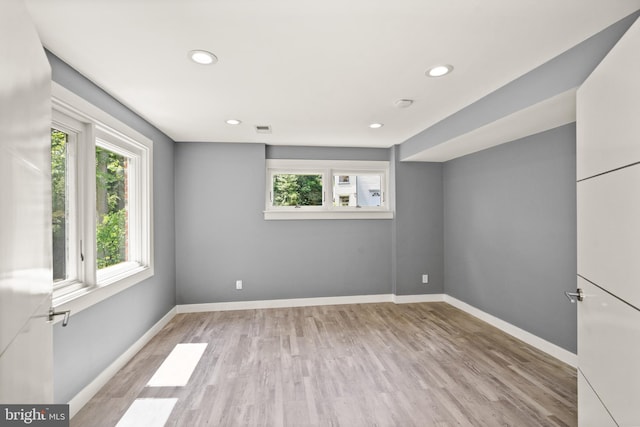 unfurnished room with light wood-style floors, baseboards, visible vents, and recessed lighting