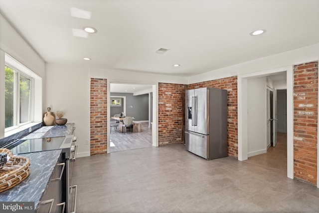 kitchen with brick wall, visible vents, stainless steel appliances, and recessed lighting