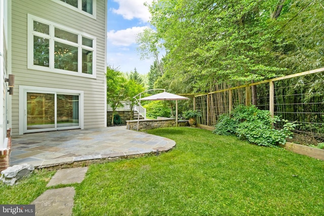 view of yard with stairway, a patio area, and a fenced backyard