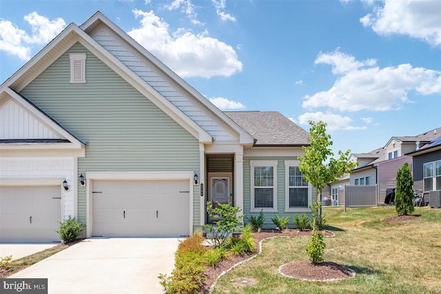 view of front of property featuring a garage, a front yard, and central AC